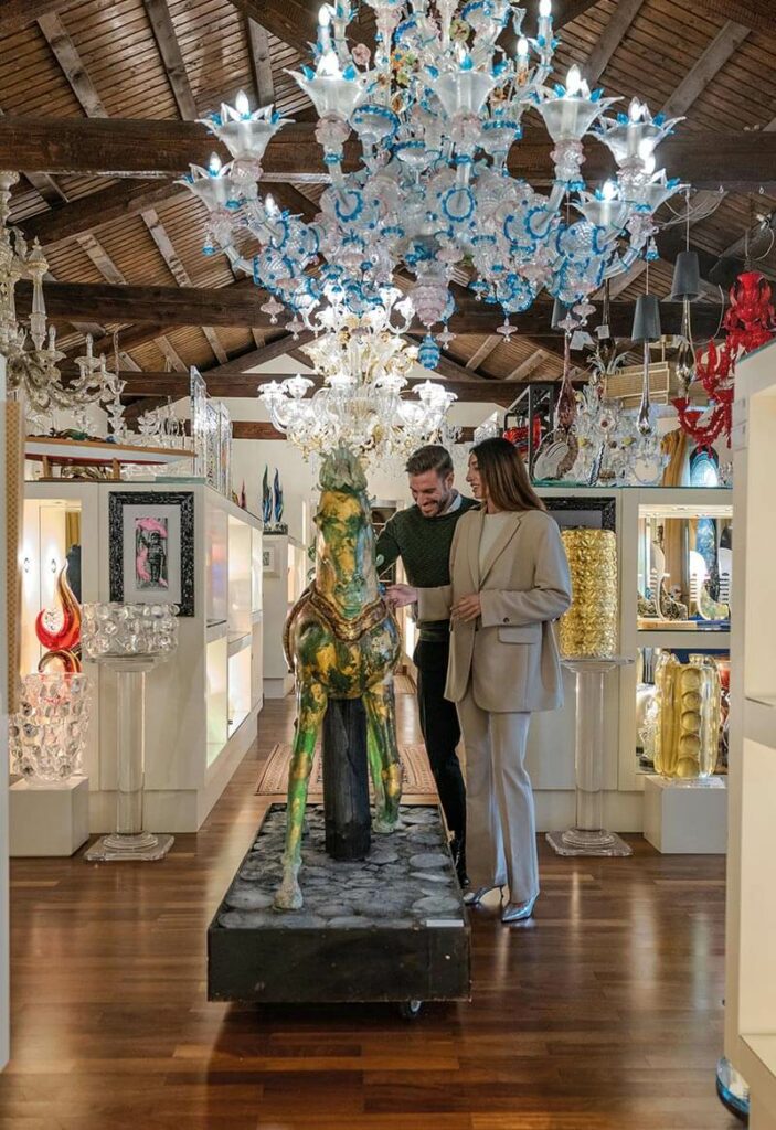 Couple admiring Murano glass chandeliers during a VLS tailor-made Venice tour
